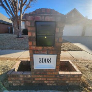 Finished brick mailbox rebuild with black mailbox and white address panel